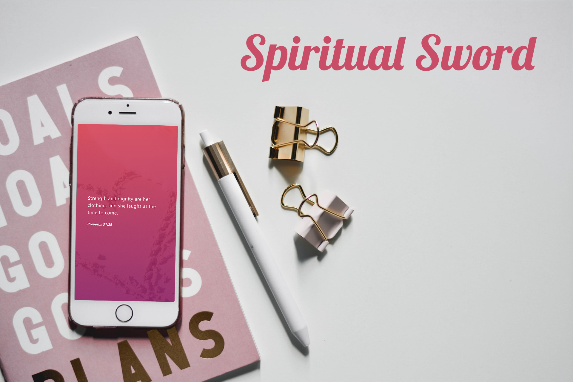 Phone showing Spiritual Sword verse design with desk items